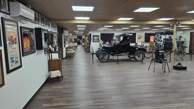 Interior of the Once Upon a Time in America Museum showing a Model T, antique projector, and gallery walls extending back through the room
